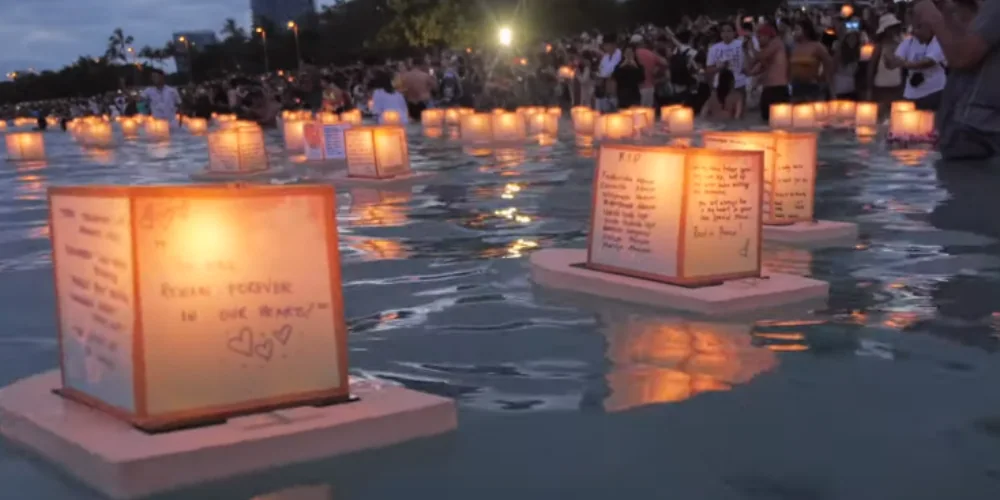 Shinnyo lantern floating festival Hawaii, people floats lantern with written wishes and prayers